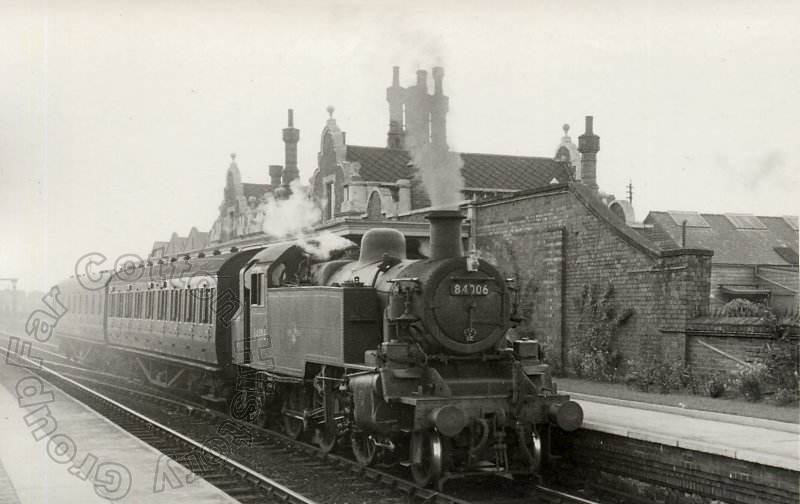Standard Class 2MT 2-6-2T no. 84006 passes Northampton Bridge Street Station with the 4:24pm train from Northampton Castle to Wellingborough Midland Road. 29 April 1959. Courtesy Robin Puryer